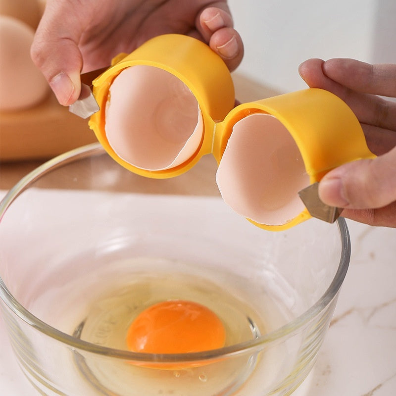 hands using a mess-free egg cracker tool to crack an egg into a bowl with egg white and yolk visible