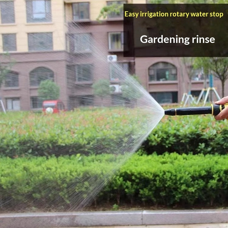 Garden Watering Hose in use with adjustable nozzle spraying water over plants in a garden setting.
